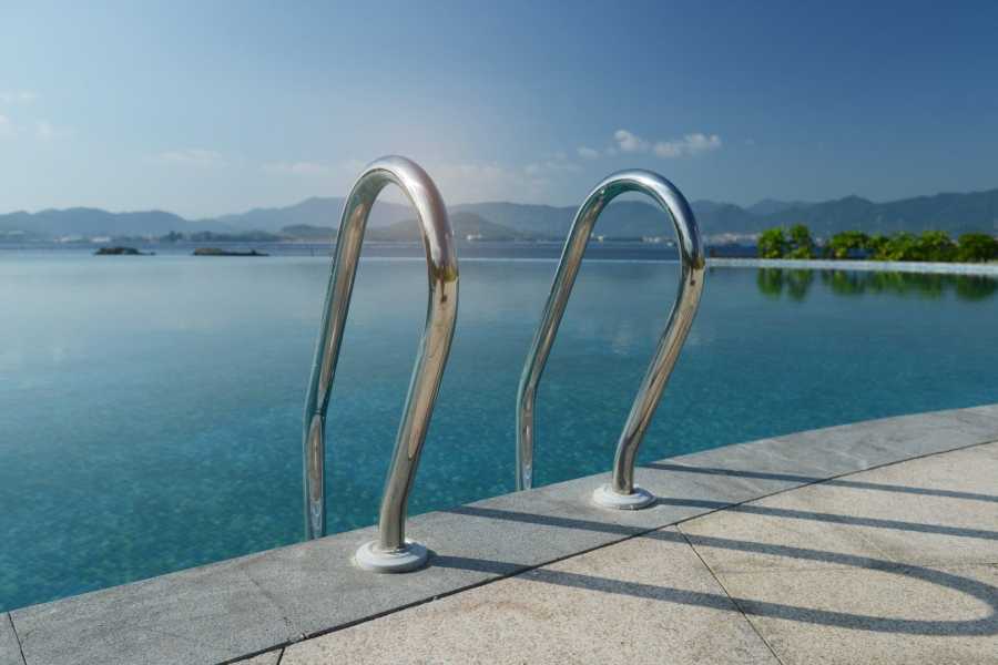 Pool for swimming located in the garden positioned over the underground parking area.