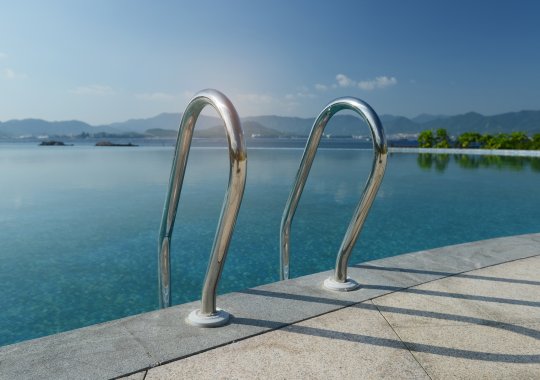 Pool for swimming located in the garden positioned over the underground parking area.
